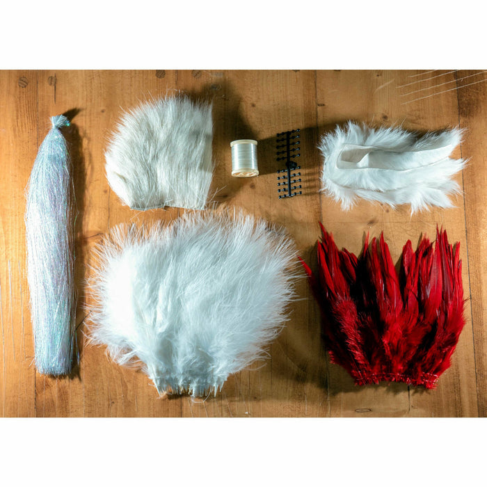 Butts' Big Money Minnow DIY Kit materials including silver tinsel, white fur, and black eyes for tying saltwater fishing flies