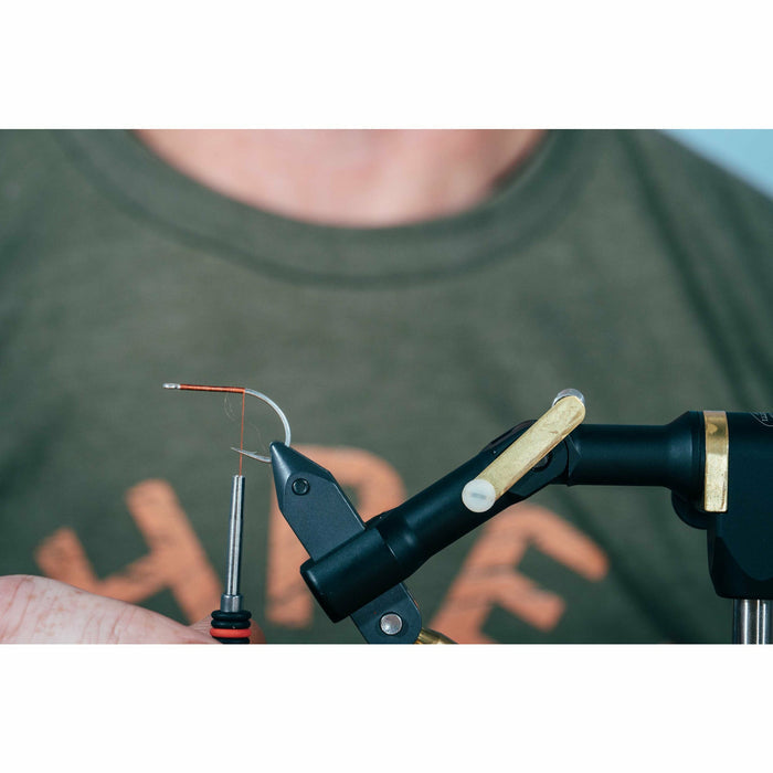 Copper wire wrap and white base material on fly tying vise