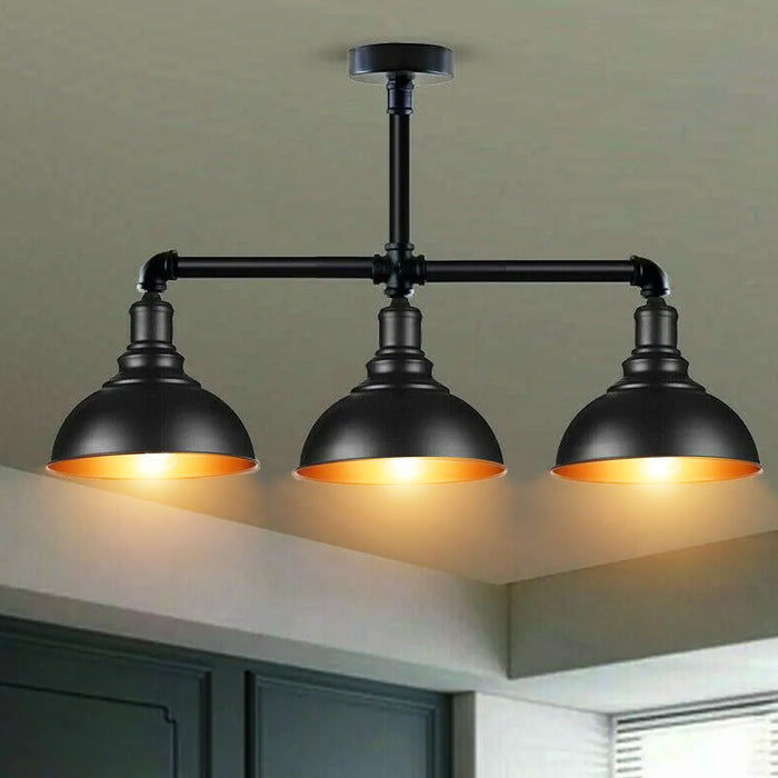 A vintage pendant ceiling light fixture with three bulb holders, in a dark color, likely black, with an industrial metal design.