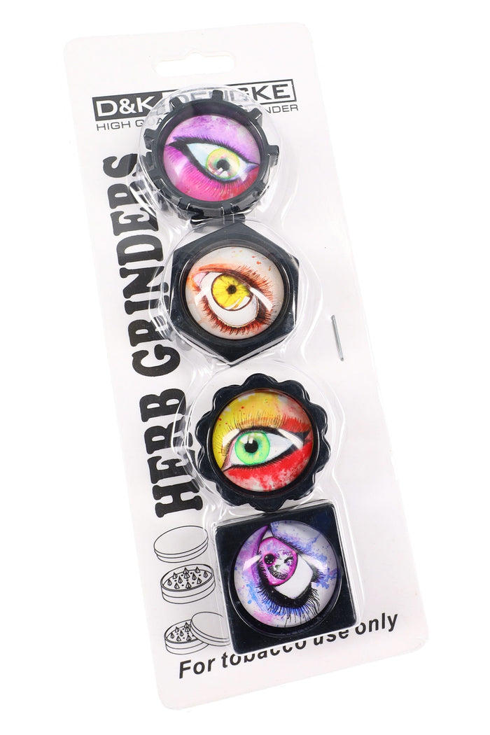 Plastic mini herb grinder gift set with four 2-part grinders, eyeball graphics, assorted shapes, and magnetic closure for travel use.