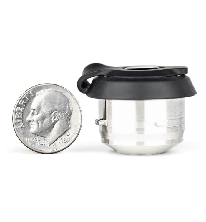 Side view of Proxy 3D Chamber beside a dime to show scale, small stainless unit with black cap and low profile.