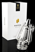 Angled shot of Ryan Fitt Recycler Glass 2.0 with Special Edition Puffco packaging on a black background for a premium look.